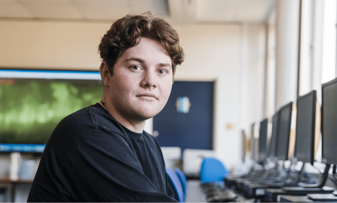 Man in a computer lab looking at the camera