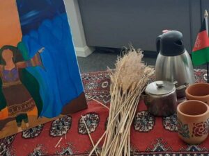 Traditional Afghanistan rug, artwork and terracotta cups being used for Afghanistan Day at Harrogate College