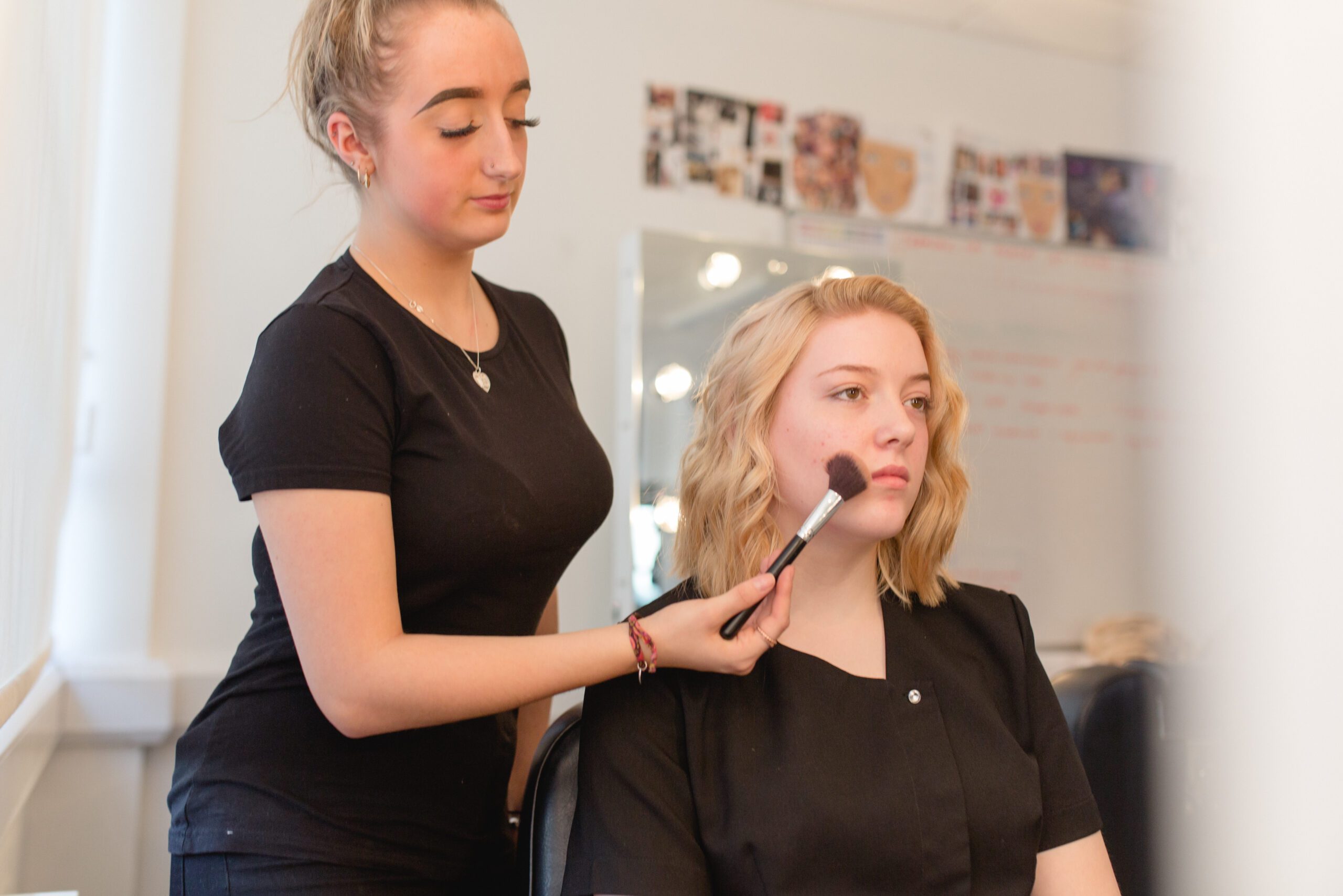 Harrogate College student applying make up to a client