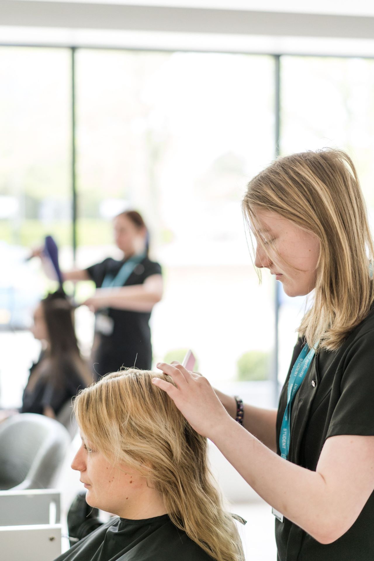 Harrogate College Hair and beauty student cutting a clients hair