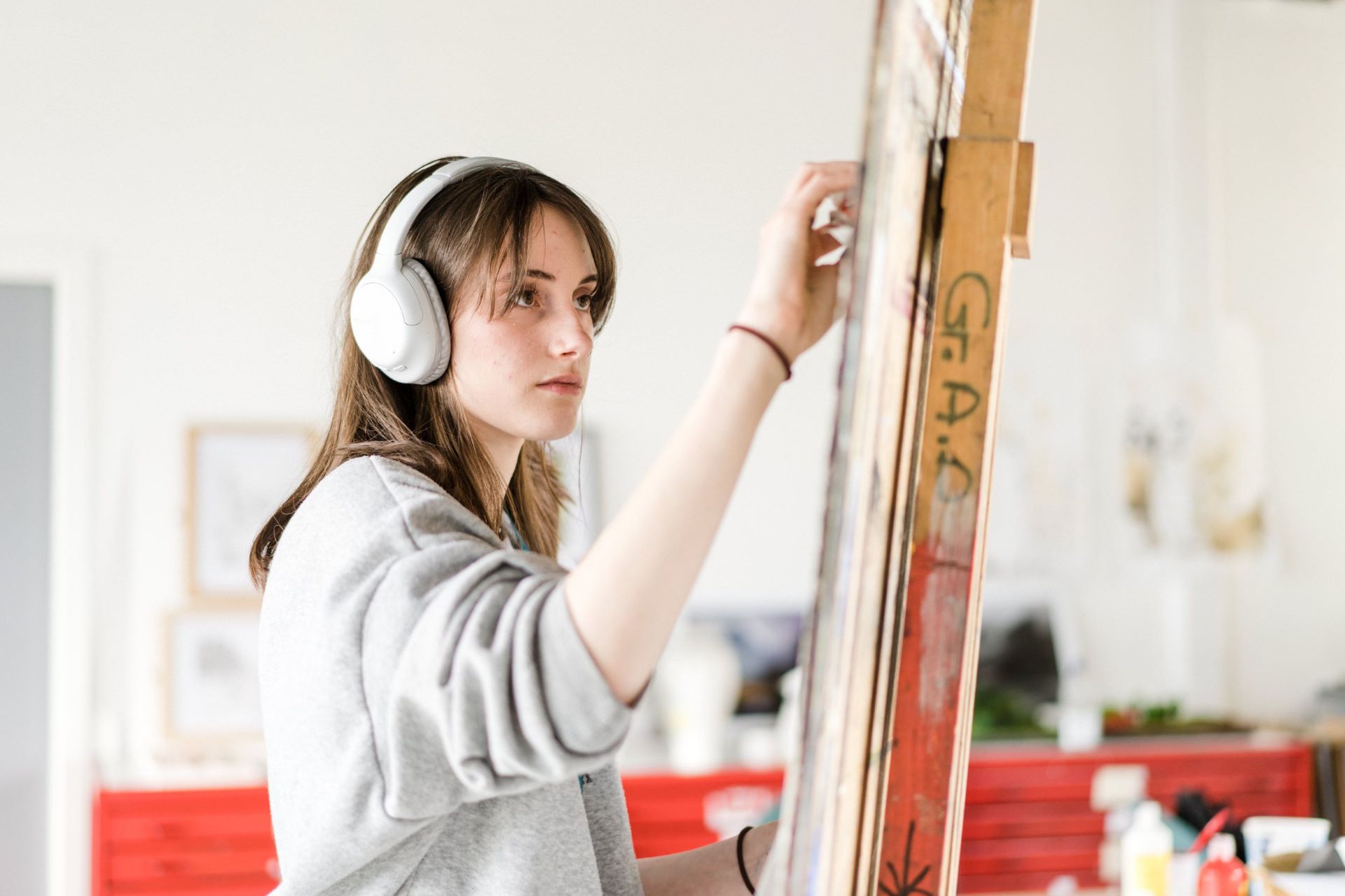 Harrogate College art and design student painting on an easel