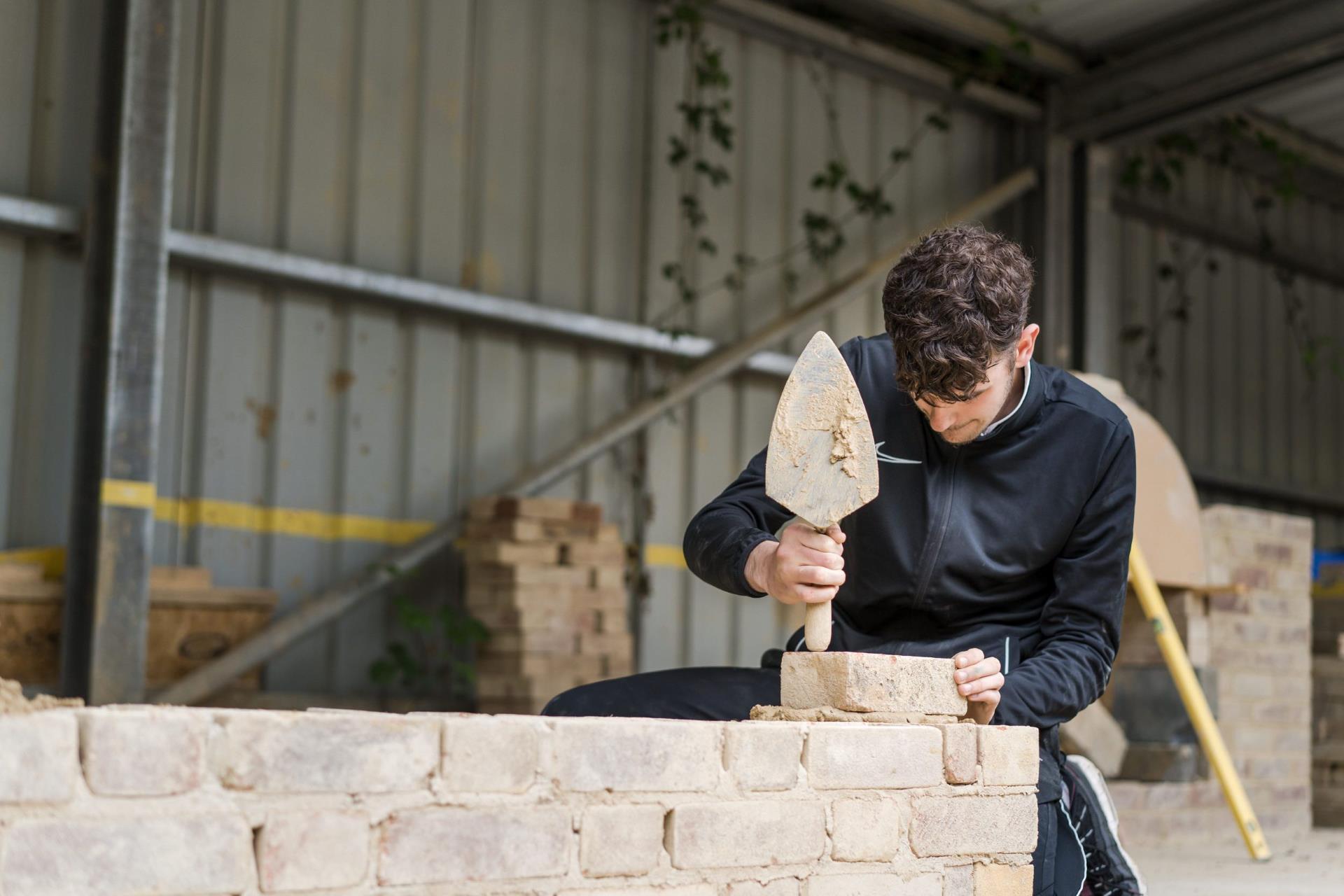 Harrogate College construction student laying bricks