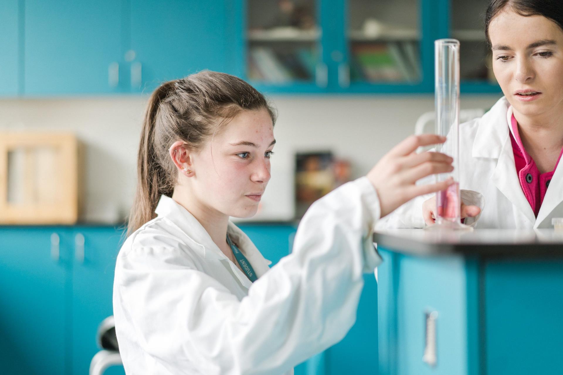 Harrogate College science student holding a test tube with chemicals