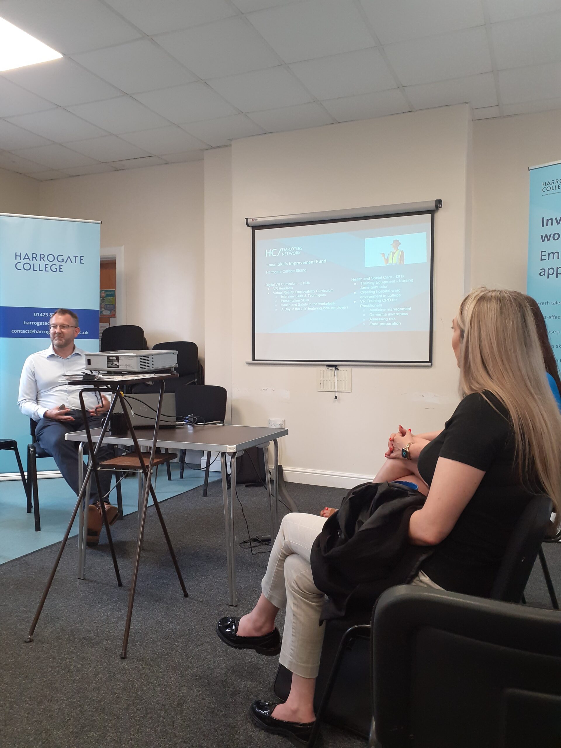 Attendees viewing presentation that display on a projector screen at the Harrogate College Employer Network event