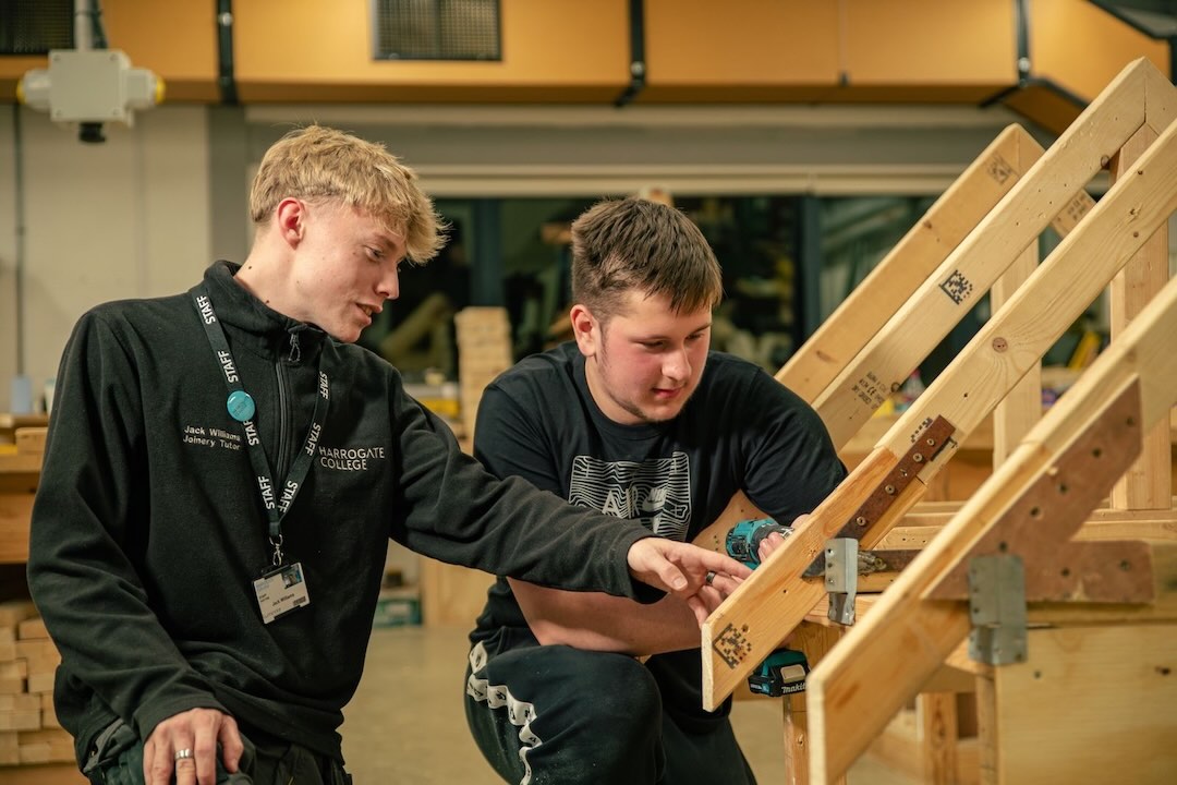 Construction and Joinery teacher showing a student how to construct a frame
