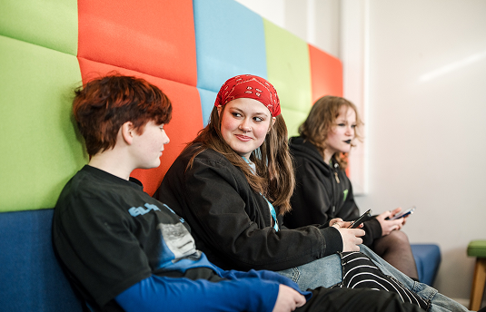 Students sat on a sofa socialising
