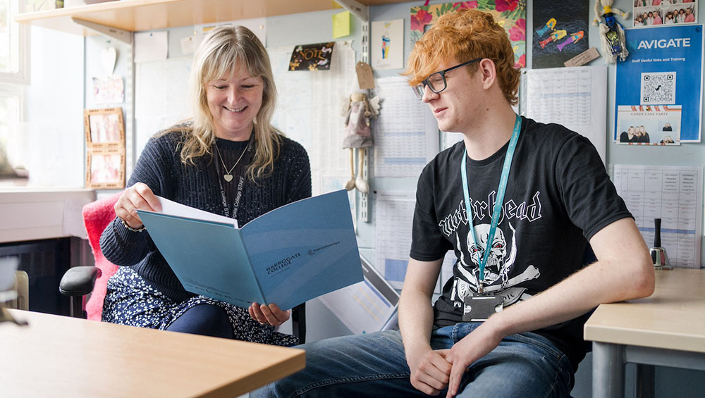 Apprenticeship mentor sat looking through booklet with apprentice in Harrogate College