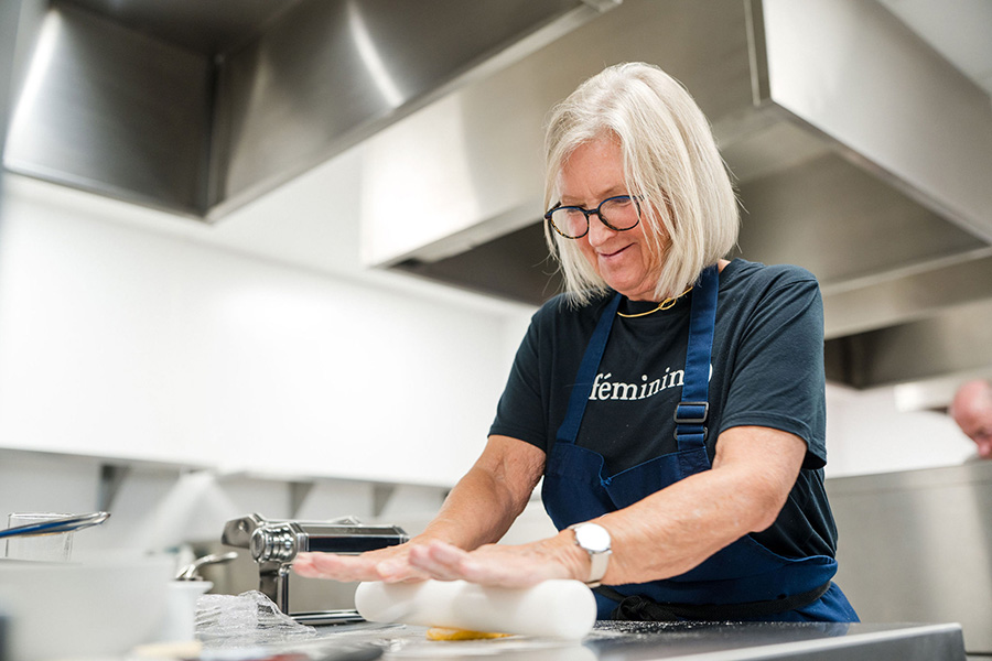 Adult student rolling pastry wearing apron in the Harrogate College kitchens