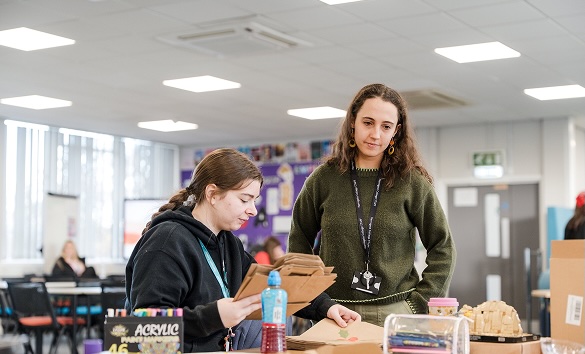 A student and teacher at Harrogate College crafting paper bags