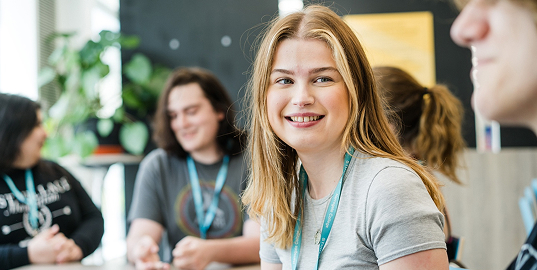 A group of learners in class smiling