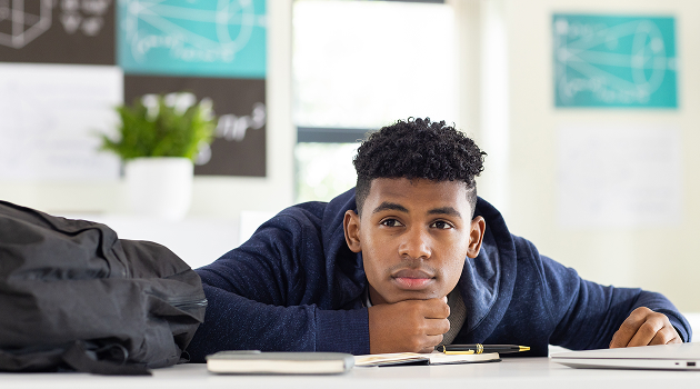 Harrogate college student resting head on hands while