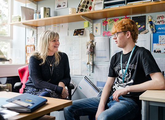 Apprenticeship mentor sat talking in their office with apprentice