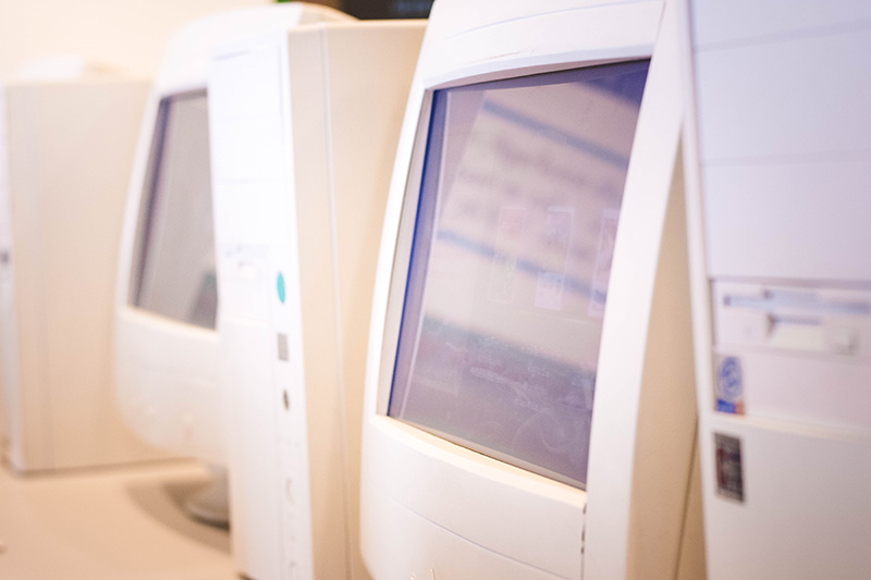 Two desktop computers and hard drives from the 90s