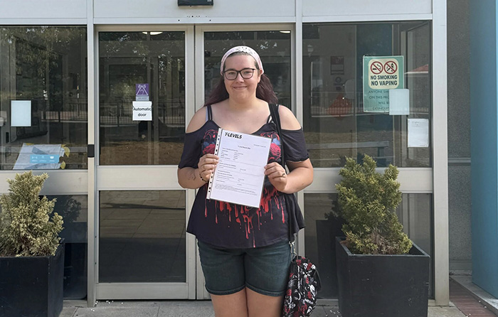Student Carmen Ronda-Perez stands outside Harrogate College with results certificate