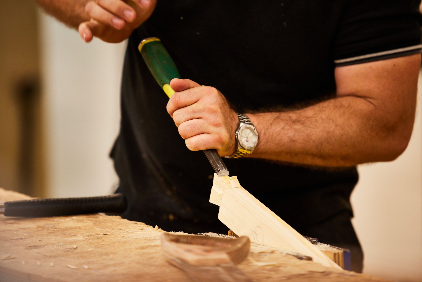 Joinery and carpentry teacher making wood joints