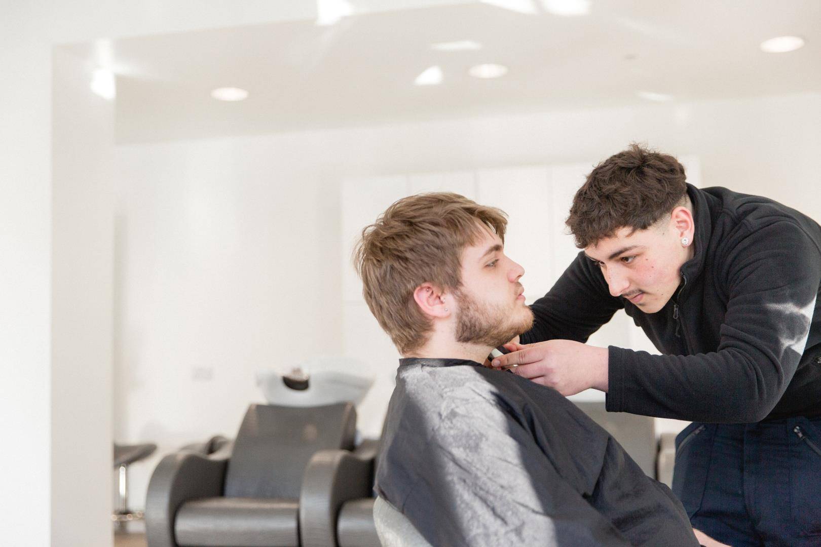 Harrogate College student trimming a clients beard