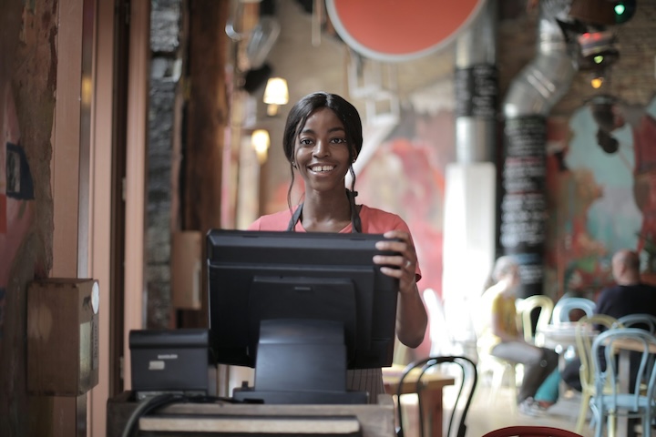 Hospitality worker at the front desk of a restaurant