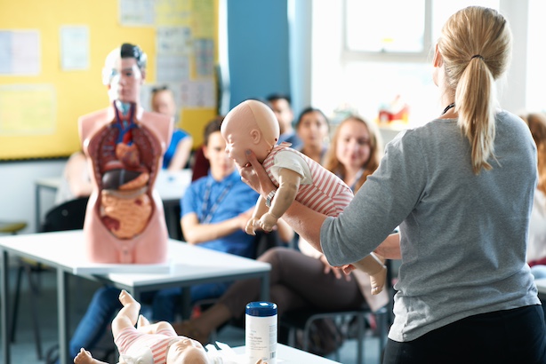 Lecturer speaking to college students in childcare
