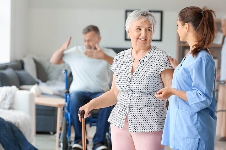 Elderly woman with caregiver in nursing home