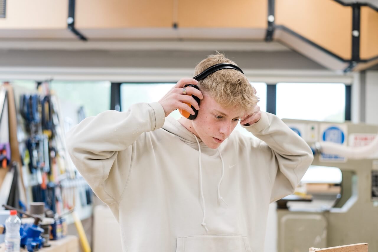 Student wearing protective ear defenders