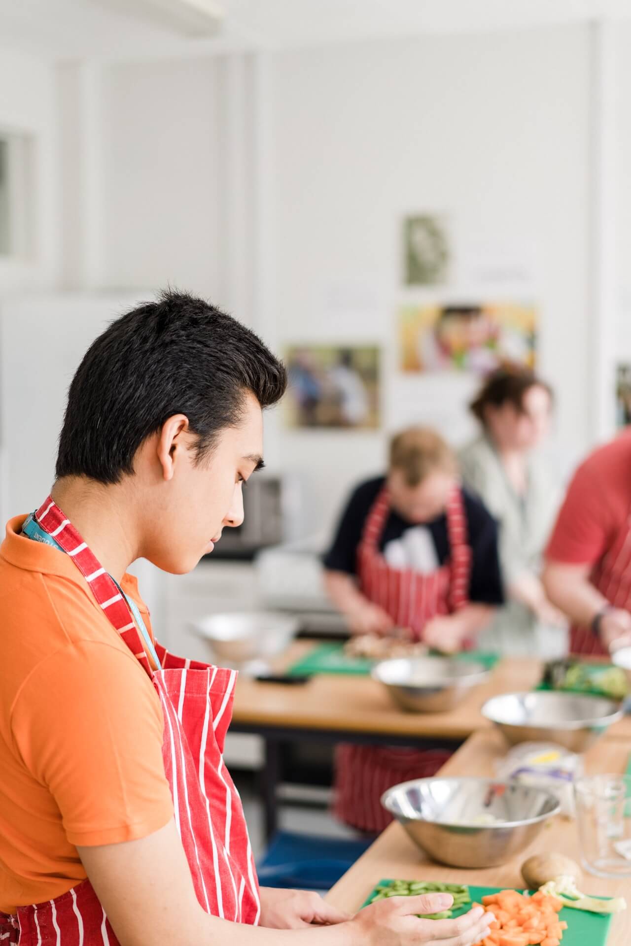 A student chef chopping vegetables