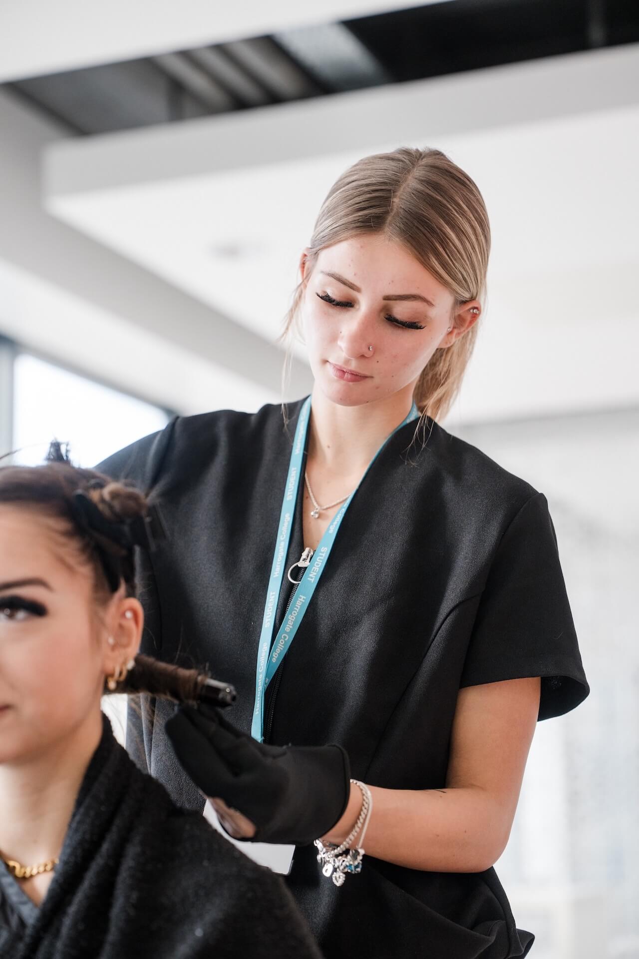A student styling hair