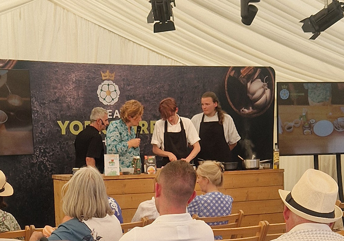 Students cooking on stage at the Great Yorkshire Show in front of an audience